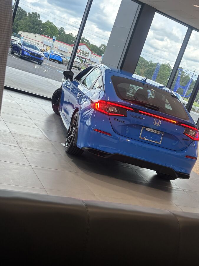 Freshly detailed Honda Civic on the dealership showroom floor